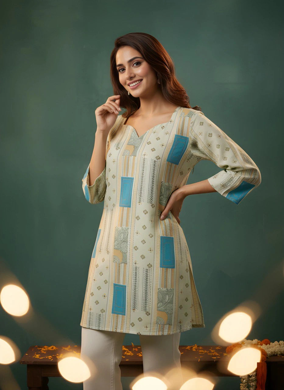 Woman wearing a patterned kurta with blue accents against a dark green background